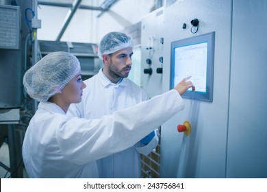 Food Technicians Working Together In A Food Processing Plant