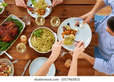 food, thanksgiving day, eating and leisure concept - people with pasta having dinner