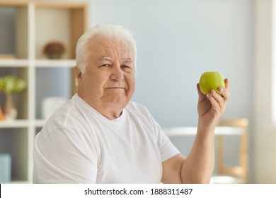 Food That's Good For Health. Senior Holding Green Apple, Motivating You To Keep Healthy Diet In Old Age. Mature Man Recommends Eating Raw Fruit And Reminds That An Apple A Day Keeps The Doctor Away