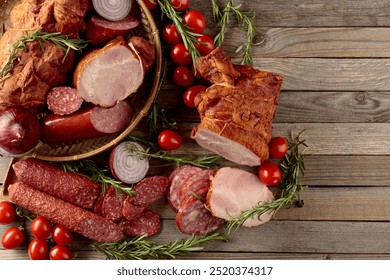 Food tray with delicious salami, ham, fresh sausages, tomato, and rosemary. Meat platter with a selection. Copy space. - Powered by Shutterstock