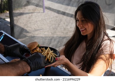 Food Truck Chef Giving Hamburger To Customer