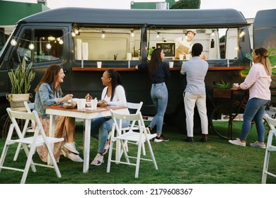 Food truck customers chatting with each other and vendor - Powered by Shutterstock