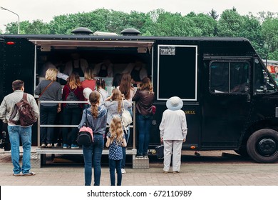 food van truck. group of people customers at mobile van with burgers and bbq at street food festival. food truck with snacks and drinks at eating market - Powered by Shutterstock