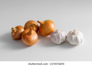 food, vegetable and healthy eating concept - onion and garlic on table