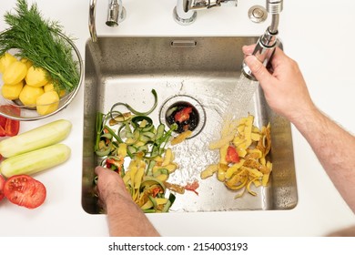 Food waste after peeling vegetables is destroyed using the Disposer - Shutterstock ID 2154003193