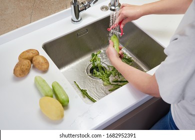Food waste disposer machine in sink in modern kitchen - Shutterstock ID 1682952391