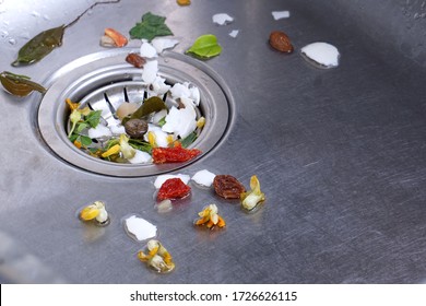 Food Waste From The Washing Up In The Sink And Trash Traps Grid Of Drainage Holes. The Garbage Is Filtered With A Sieve And Placed In The Trash For Disposal.