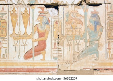 Food And Wine Priestesses An Ancient Egyptian Hieroglyphic Carving Showing Two Goddesses Carrying Wine And Food Offerings For The Gods. Temple Of Ramses, Abydos, Egypt.