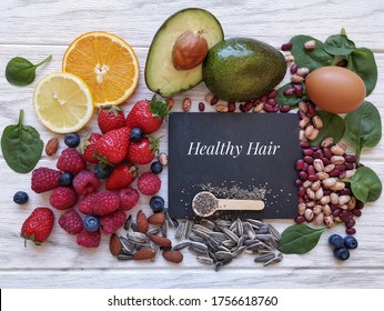 Foods For Healthy Long Hair. Best Beauty Foods For Shiny, Strong Hair. Concept Of Hair Growth Food. Fresh Berries, Citrus Fruit, Almond, Avocado, Spinach, Beans, Eggs, Sunflower And Chia Seeds.