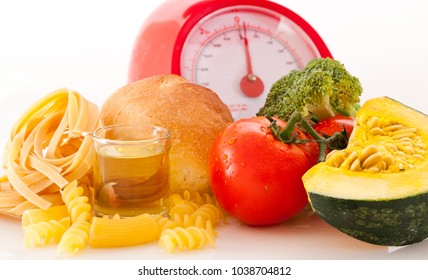 Foods high in carbohydrate on a scales - Shutterstock ID 1038704812