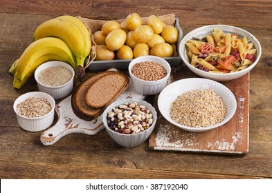 Foods high in carbohydrate on wooden background. Top view