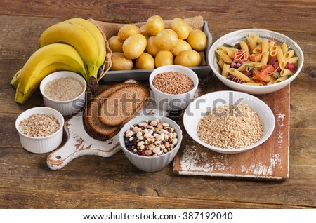 Foods high in carbohydrate on wooden background. Top view
