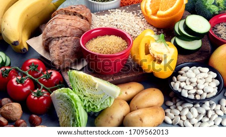 Foods high in carbohydrates on grey background. Vegan Foods high in dietary fiber, antioxidants, vitamins and minerals. 