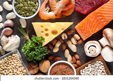 Foods High in Zinc as salmon, seafood-shrimps, beef, yellow cheese, parsley leaves, mushrooms, cocoa, pumpkin seeds, garlic, bean, almonds, pine nut. Top view