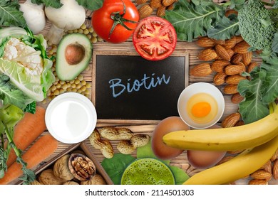 Foods Rich In Biotin. Foods As Eggs, Soybeans, Milk, Cauliflower, Mushrooms, Carrot, Broccoli, Tomatoes, Banana, Avocado,  Peanuts, Walnuts And Almonds On Wooden Table.