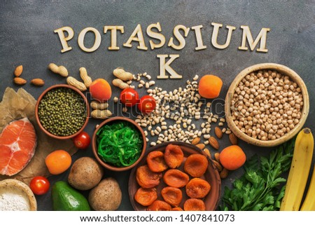 Foods rich in potassium, salmon, legumes, vegetables, fruits on a dark background. Healthy food concept,avitaminosis prevention. Top view, flat lay Stock foto © 