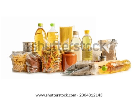 Foodstuff for donation isolated on white background with clipping path, storage and delivery. Various food, pasta, cooking oil and canned food.