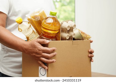 Foodstuffs in donation box for volunteer to help people. - Powered by Shutterstock