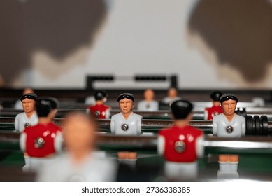 Foosball players casting dramatic shadows on wall, concept of competition and strategy