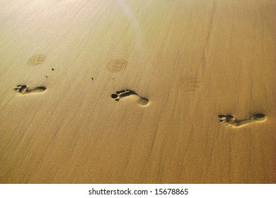 Foot And Ball Prints On Sand