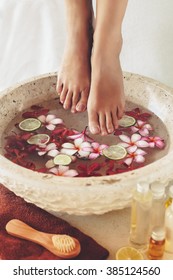 Foot Bath In Bowl With Lime And Tropical Flowers, Spa Pedicure Treatment