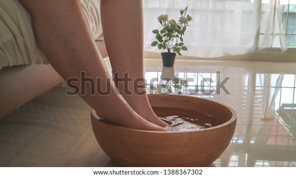 Foot\
bath in bowl and tropical, spa pedicure\
treatment,