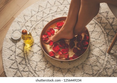 Foot bath with flower petals in massage spa.  - Powered by Shutterstock