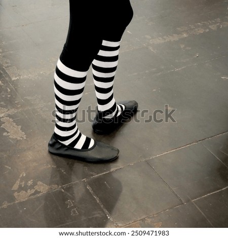 foot in extraordinay pantomime socks fashion standing of solid ground