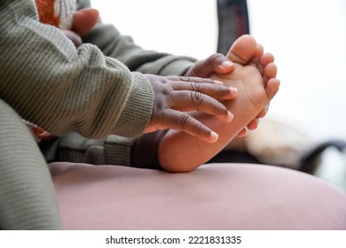 Foot And Hands Of A Black African Baby Playing