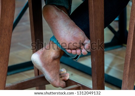 foot human under chair or man sit on the chair
