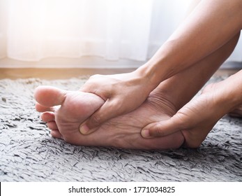 foot injury use hand massage on feet to relax muscle from heel pain, ankles and bones from inflammation of tendons. 