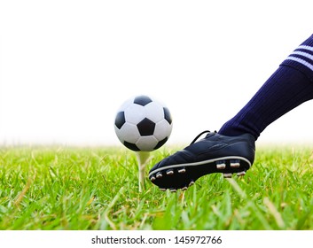 Foot Kicking Soccer Ball On Golf Tee Isolated