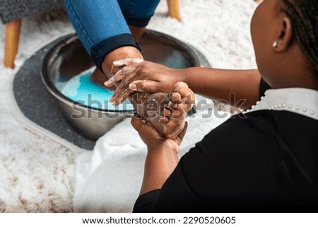 A Foot Massage Detoxifying Feet, Scrubbing And Massaging A Customer Using Natural Salts.