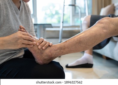 Foot massage physical therapy to relieve muscle spasms,massage the tired muscles of senior woman,feet numb from diabetes,old elderly with diabetic numbness of the toes,problems of peripheral nerves