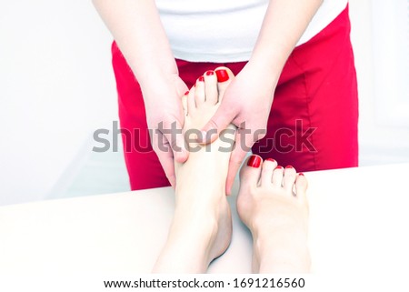 Foot massage in spa salon, closeup. foot massage relax skin care. Therapeutic pedicure.