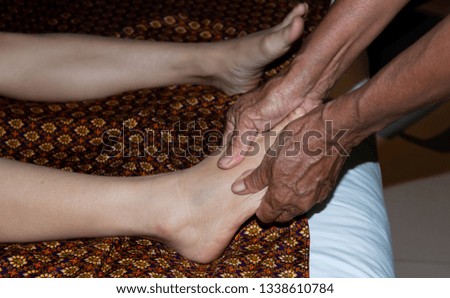 Foot massage.Traditional Thai massage,Young woman enjoying the acupressure techniques at her foot,Thai medicine,Thai reflexology spa benefits,