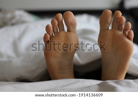 Woman’s foot, morning in the bed, massage body relax