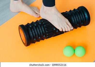 Foot On Foam Roller For Plantar Fascia Massage And Hydration. Concept: Self Care Practices At Home