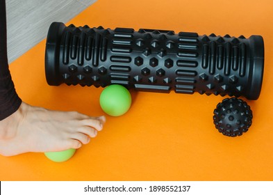 Foot On Massage Ball For Plantar Fascia Massage And Hydration. Concept: Self Care Practices At Home