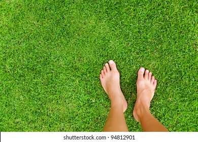 Foot over green grass