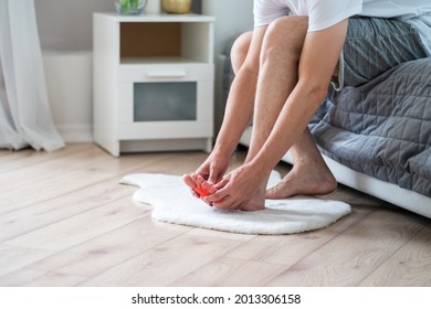 Foot Pain, Man Suffering From Feet Ache In Home Interior, Podiatry Concept