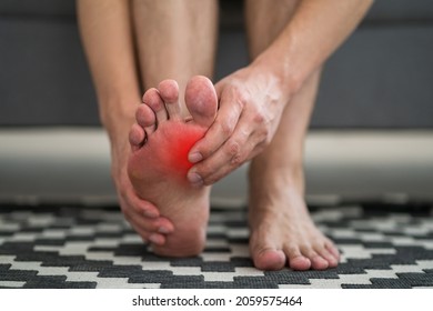 Foot Pain, Man Suffering From Feet Ache At Home, Podiatry Concept