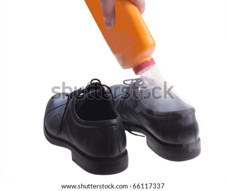 Foot powder being poured into shoe to control odor.
