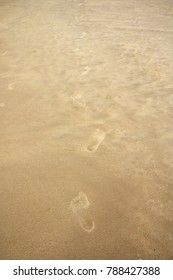 Foot Prints On Sand Beach.