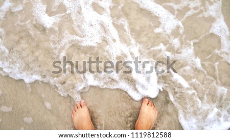 Foot and sand beach, soft wave water sea.
