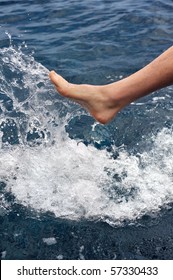 Foot of young man in water - splash