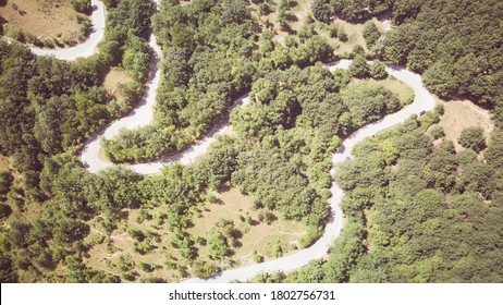 Footage B Roll Of Aerial View Drone Flying Above Landscape Serpentine Winding Road. Drone 4K Video, Road Winding On The Mountains In Summer Sunny Day