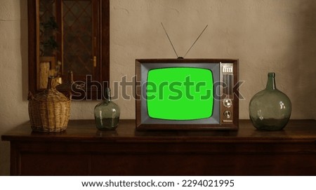 footage of Dated TV Set with Green Screen Mock Up Chroma Key Template Display, Nostalgic living room with furniture and old mirror, Chroma Key, retro style Television, vintage evening tv concept