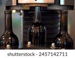 Footage showing an empty glass bottles are rolling on the alcohol bottling belt machine in the manufacturing facility. Automatic beverage bottle filling in factory. A wine bottles on conveyer moving.