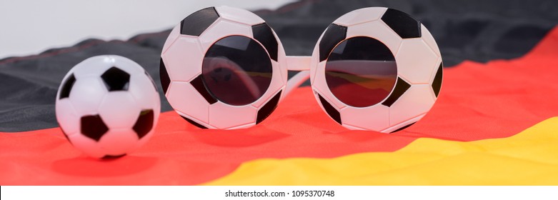 Football and abstract glasses on the german flag. Football and Soccer background - Shutterstock ID 1095370748
